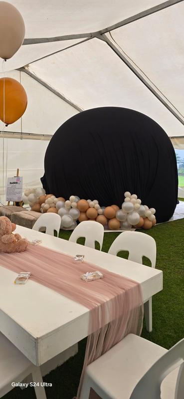 Gender reveal bubble house hire Johannesburg - covered dome with balloon garland surround